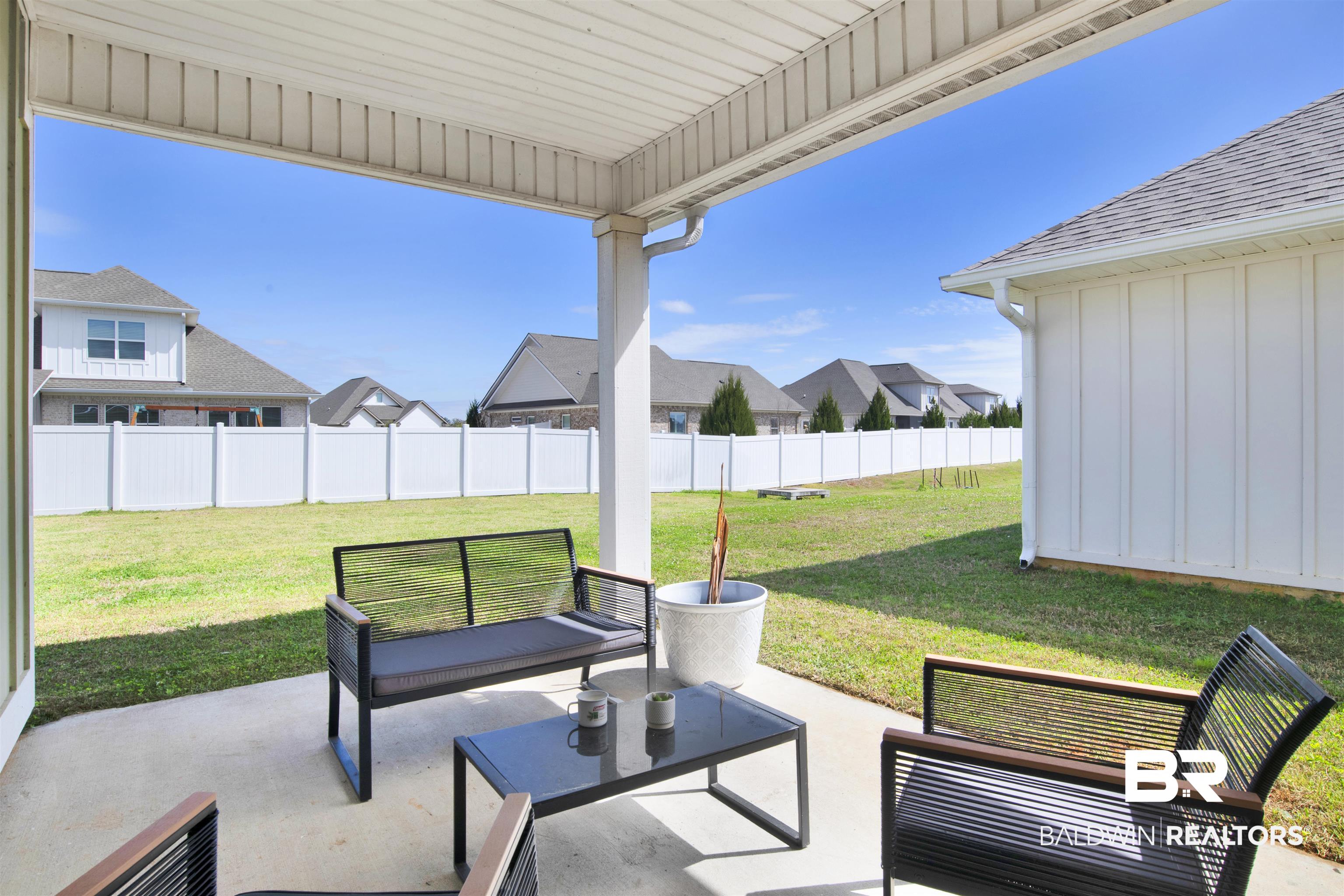 24253 Alydar Loop Daphne, AL 36526 - Photo 35 of 44 Fenced backyard with a patio, a residential view, and an outdoor living space