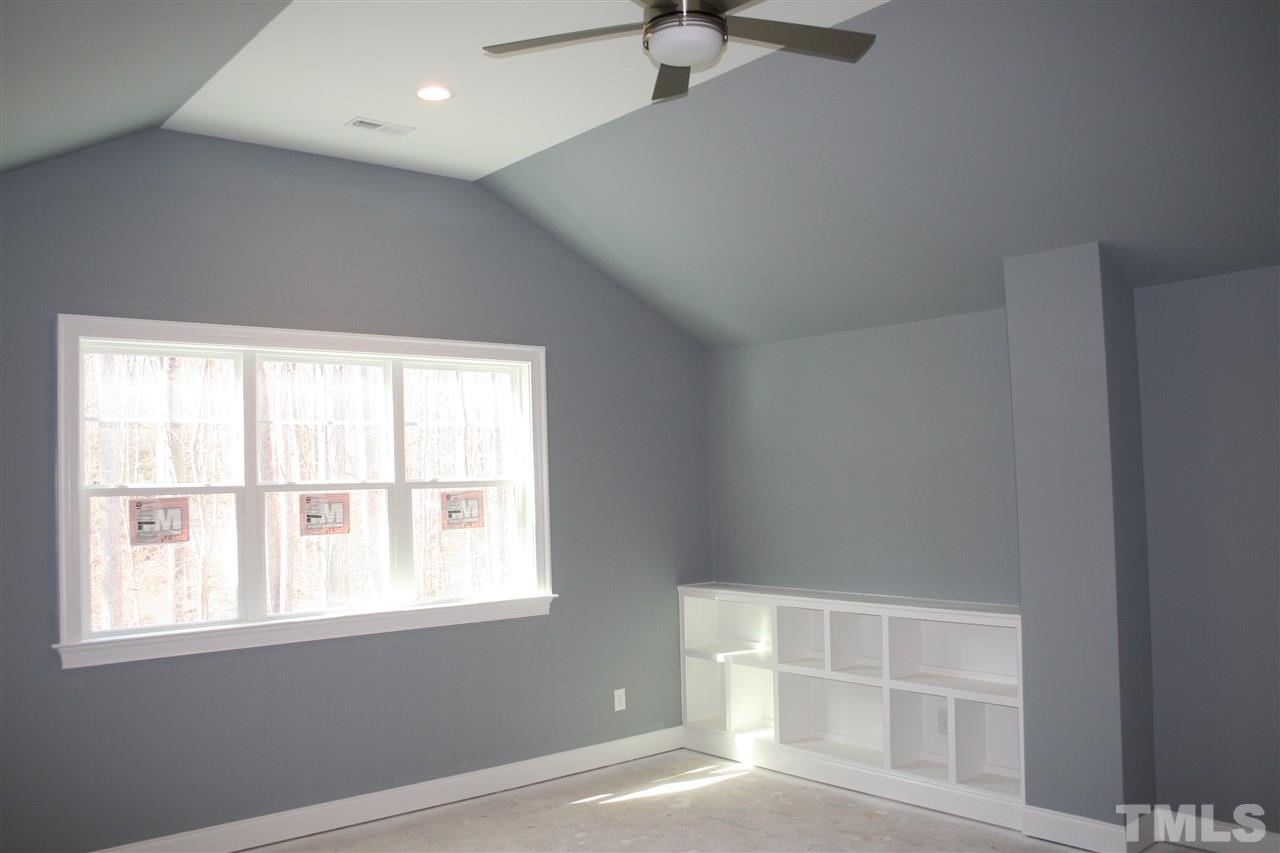 8703 Duckview Court Raleigh, NC 27613 - Photo 12 of 16 an empty room with wooden floor and windows