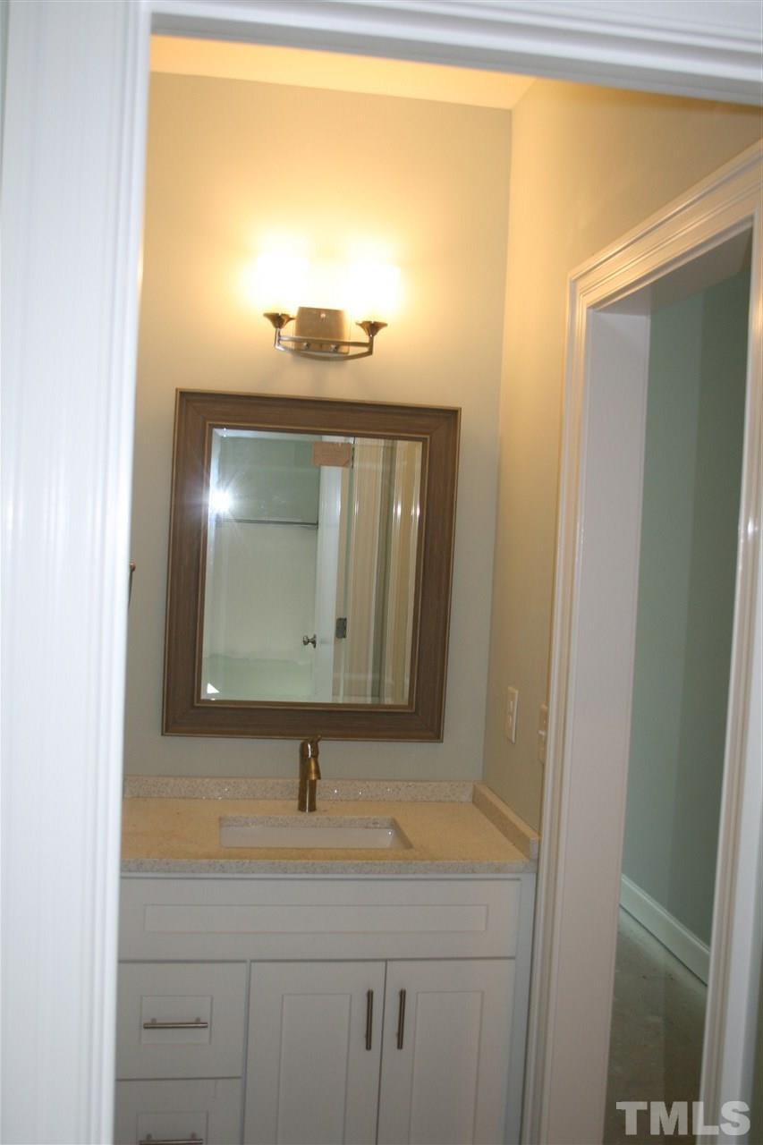 8703 Duckview Court Raleigh, NC 27613 - Photo 14 of 16 a bathroom with a sink and a mirror