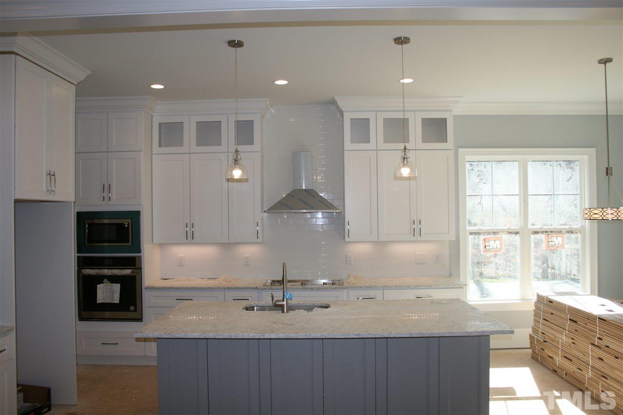 8703 Duckview Court Raleigh, NC 27613 - Photo 5 of 16 a kitchen with a sink cabinets and window