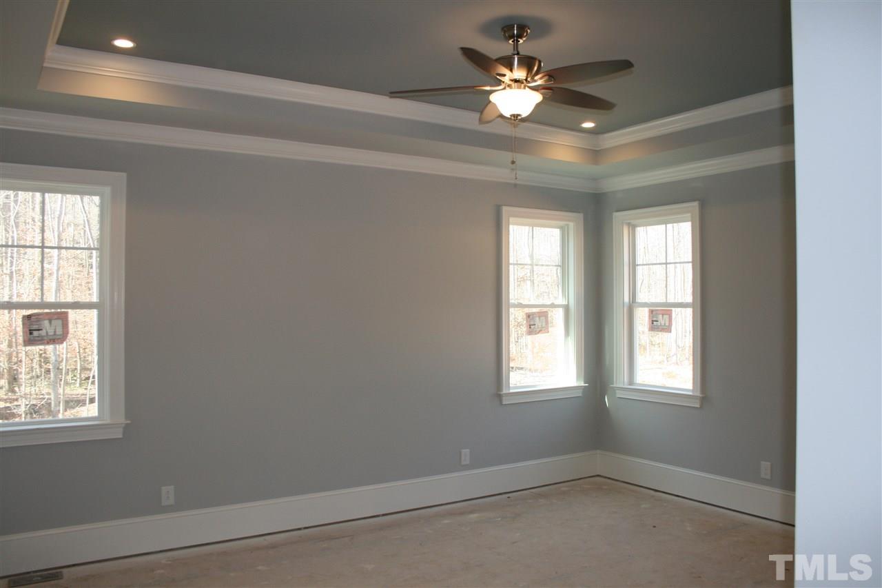 8703 Duckview Court Raleigh, NC 27613 - Photo 7 of 16 an empty room with windows and ceiling fan