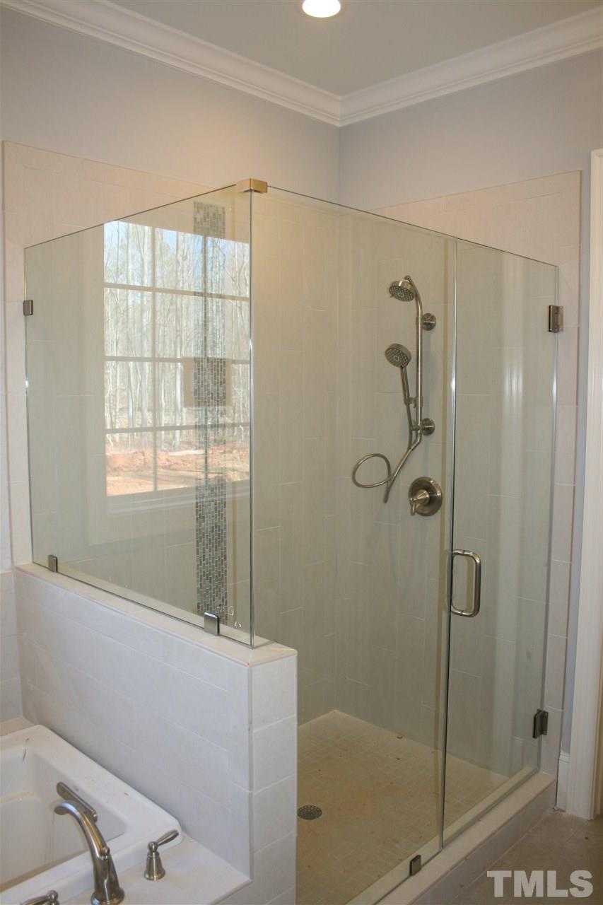 8703 Duckview Court Raleigh, NC 27613 - Photo 9 of 16 a bathroom with a bathtub and shower