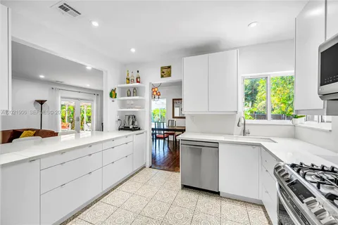 a kitchen with a sink stove and cabinets