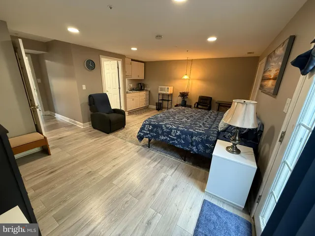 a bedroom with a bed window and a couch