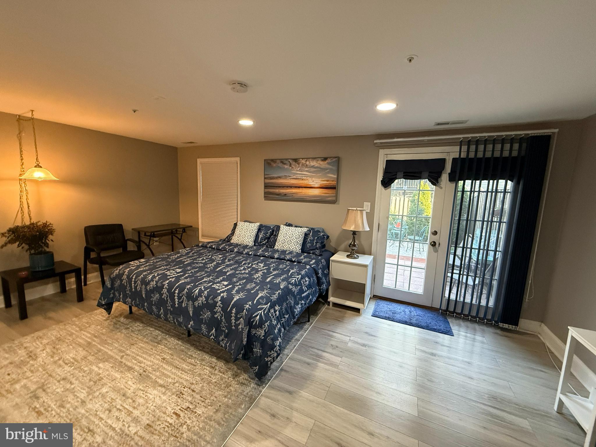 2568 Ambling Circle Crofton, MD 21114 - Photo 3 of 7 a spacious bedroom with a balcony a bed and a table in it