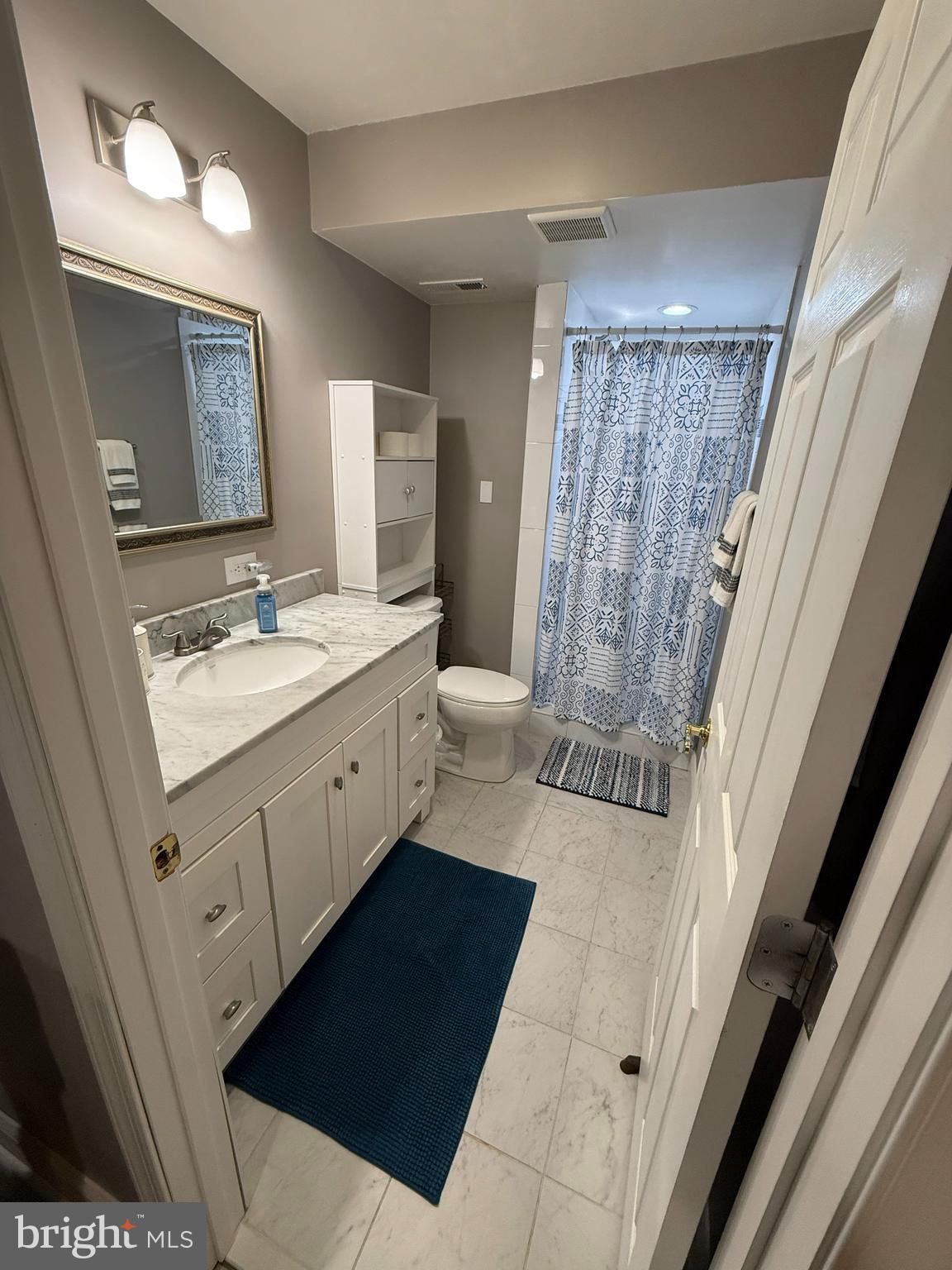 2568 Ambling Circle Crofton, MD 21114 - Photo 5 of 7 a bathroom with a double vanity sink a mirror and a shower