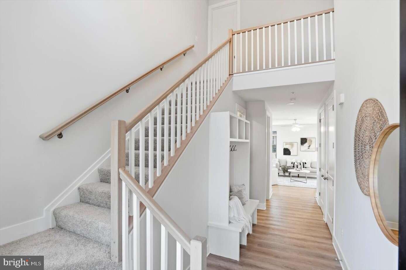 533 Forest View Road Linthicum Heights, MD 21090 - Photo 2 of 20 a view of a hallway with wooden floor and stairs