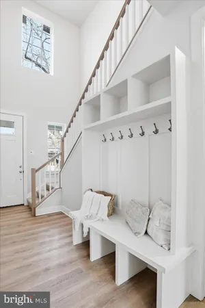 a view of entryway and hall with wooden floor