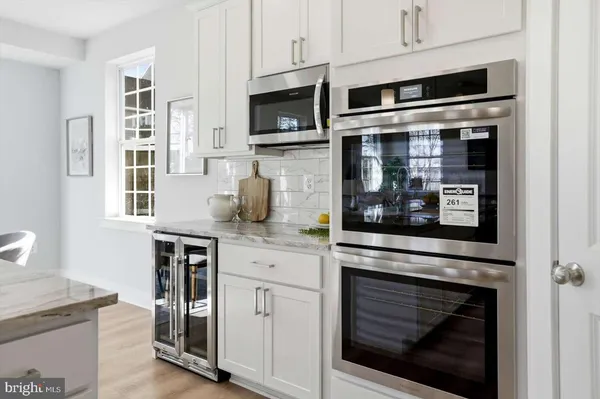 a kitchen with stainless steel appliances granite countertop a stove microwave and cabinets
