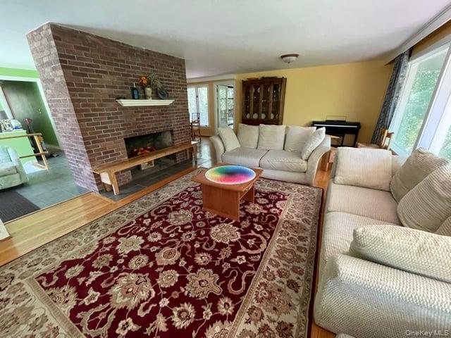 419 Triphammer Road Ithaca, NY 14850 - Photo 16 of 26 a living room with furniture a flat screen tv and a fireplace