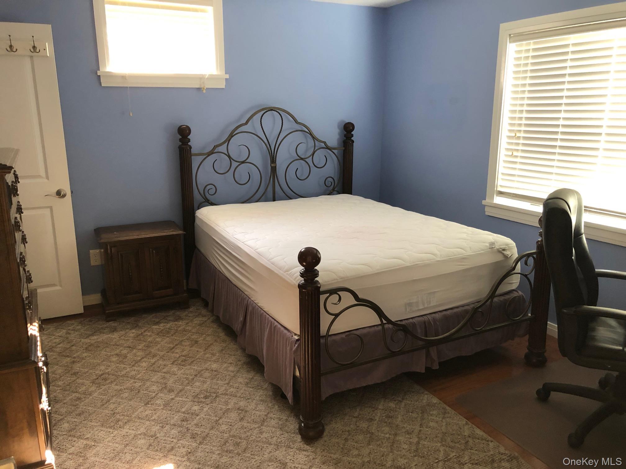 419 Triphammer Road Ithaca, NY 14850 - Photo 22 of 26 a bed sitting in a bedroom next to a window