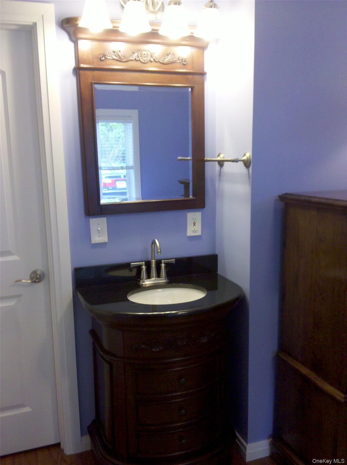 419 Triphammer Road Ithaca, NY 14850 - Photo 23 of 26 a bathroom with a sink and a mirror