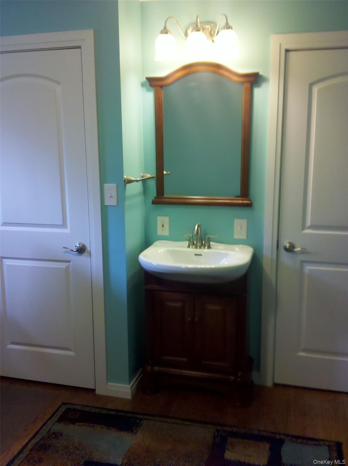 419 Triphammer Road Ithaca, NY 14850 - Photo 24 of 26 a bathroom with a sink and a mirror