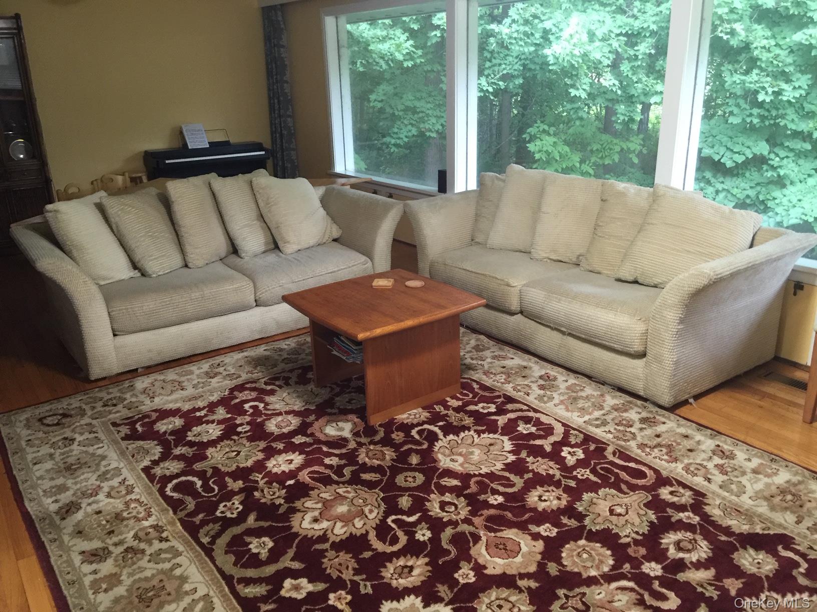 419 Triphammer Road Ithaca, NY 14850 - Photo 26 of 26 a living room with furniture and a rug