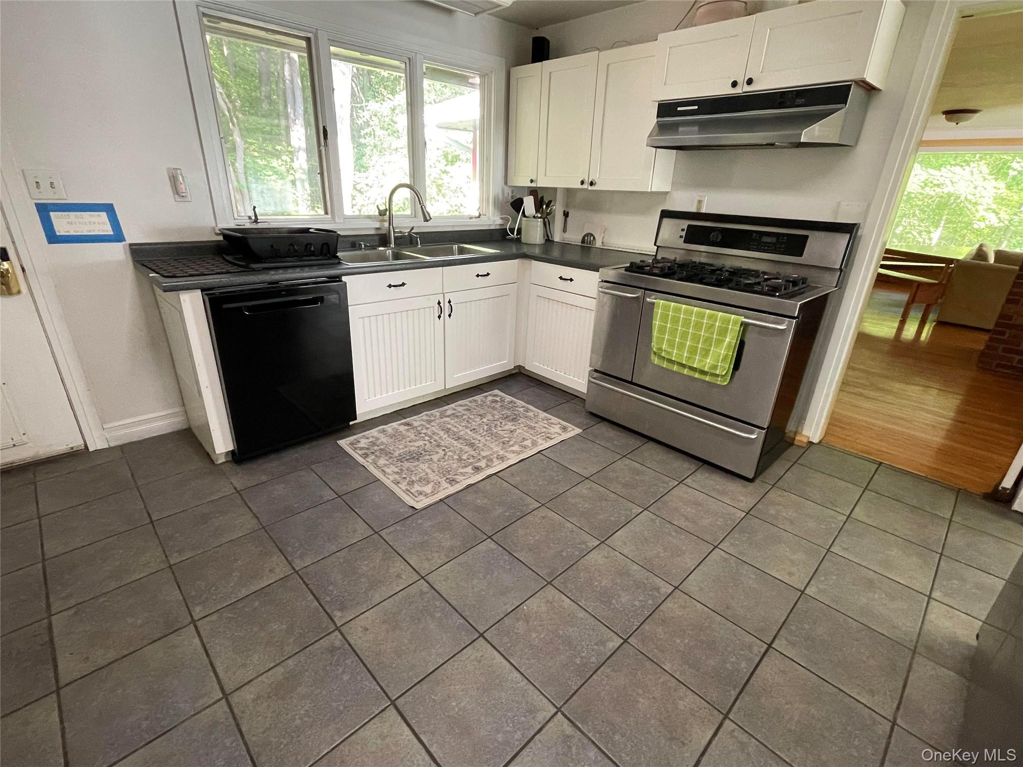 419 Triphammer Road Ithaca, NY 14850 - Photo 6 of 26 a kitchen with stainless steel appliances granite countertop a stove a sink and a microwave