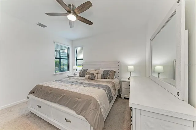 a view of a house with a big yard and palm trees