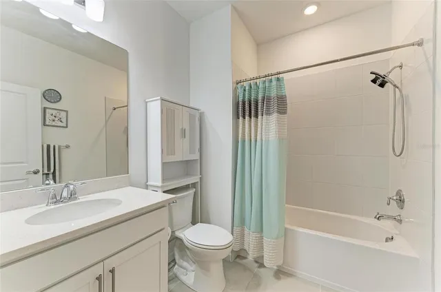 a kitchen with stainless steel appliances kitchen island granite countertop a refrigerator stove and sink