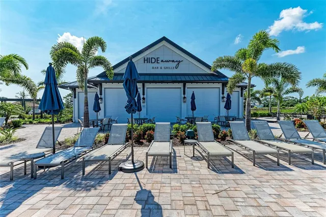 a front view of a house with a yard and a garden