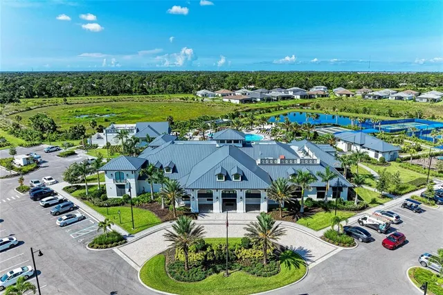 an aerial view of a residential houses with outdoor space and swimming pool
