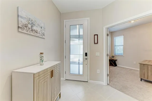 a living room with furniture fireplace and a large window