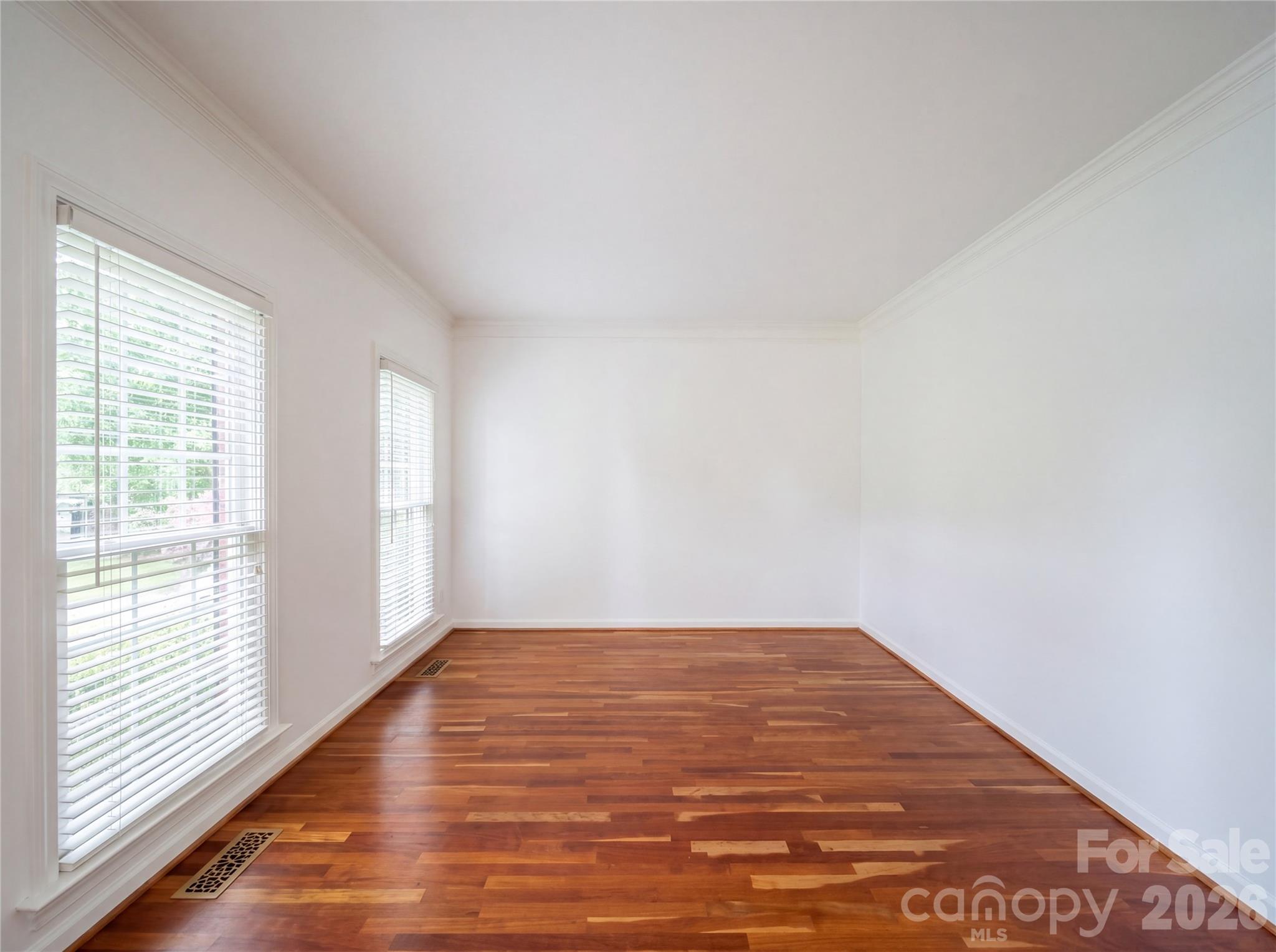 12341 Willingdon Road Huntersville, NC 28078 - Photo 9 of 17 a view of empty room with wooden floor and fan