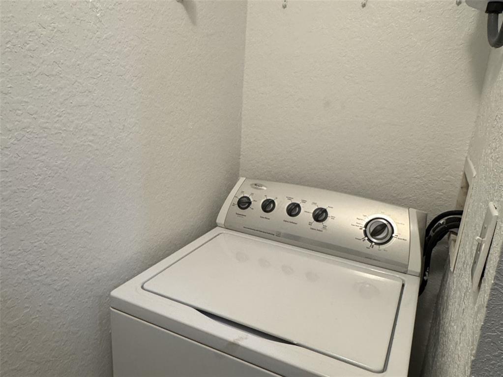 5483 Vineland Road, Unit 10201 Orlando, FL 32811 - Photo 11 of 35 a utility room with dryer and washer