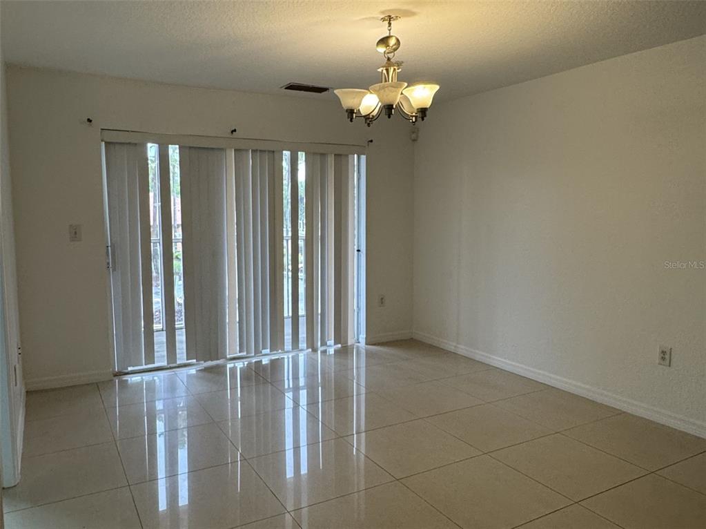 5483 Vineland Road, Unit 10201 Orlando, FL 32811 - Photo 15 of 35 a view of a livingroom with a chandelier