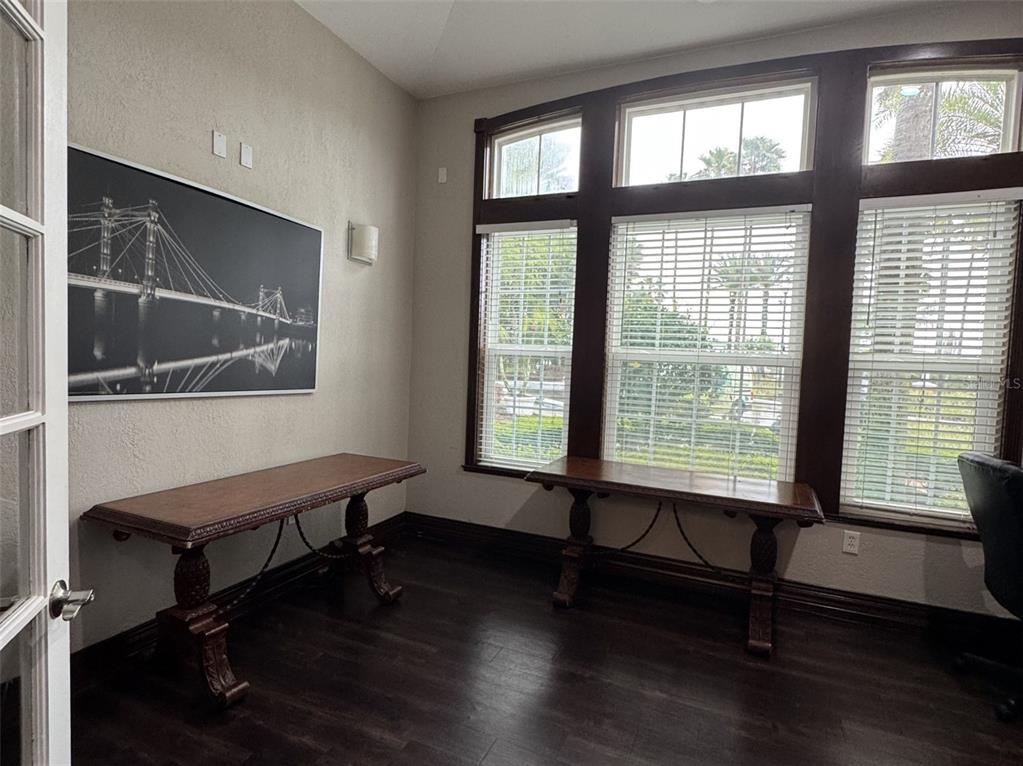 5483 Vineland Road, Unit 10201 Orlando, FL 32811 - Photo 31 of 35 a living room with wooden floor and a window