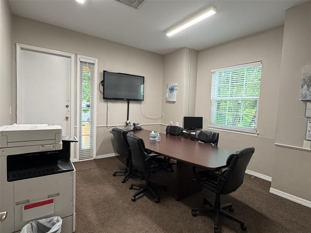 5483 Vineland Road, Unit 10201 Orlando, FL 32811 - Photo 32 of 35 a workspace with computers on desk and chair