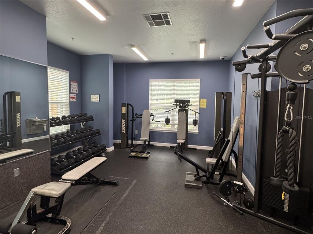5483 Vineland Road, Unit 10201 Orlando, FL 32811 - Photo 34 of 35 a view of a room with gym equipment