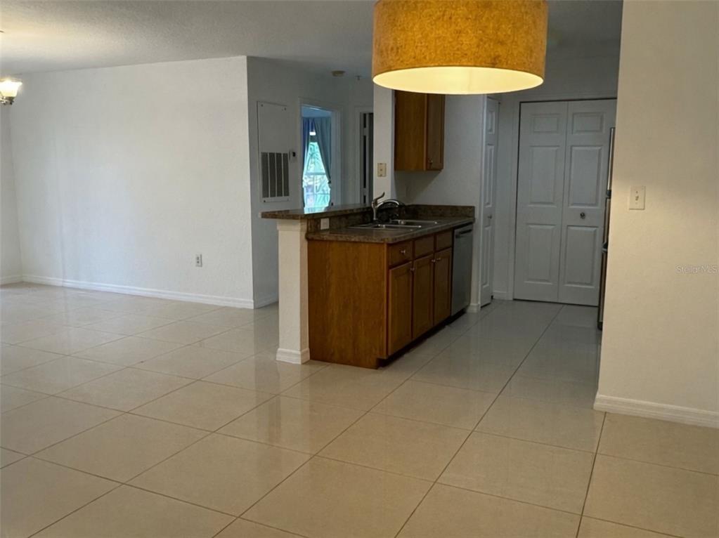 5483 Vineland Road, Unit 10201 Orlando, FL 32811 - Photo 5 of 35 a kitchen with stainless steel appliances a sink stove and cabinets