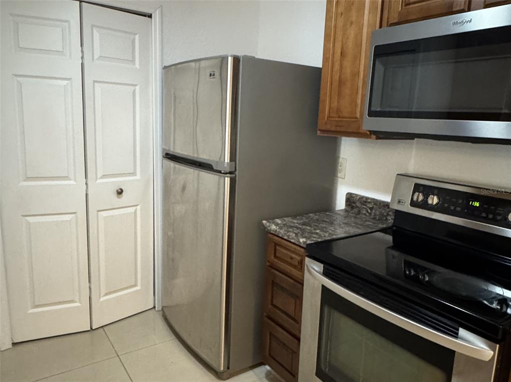 5483 Vineland Road, Unit 10201 Orlando, FL 32811 - Photo 8 of 35 a kitchen with a stove microwave and refrigerator