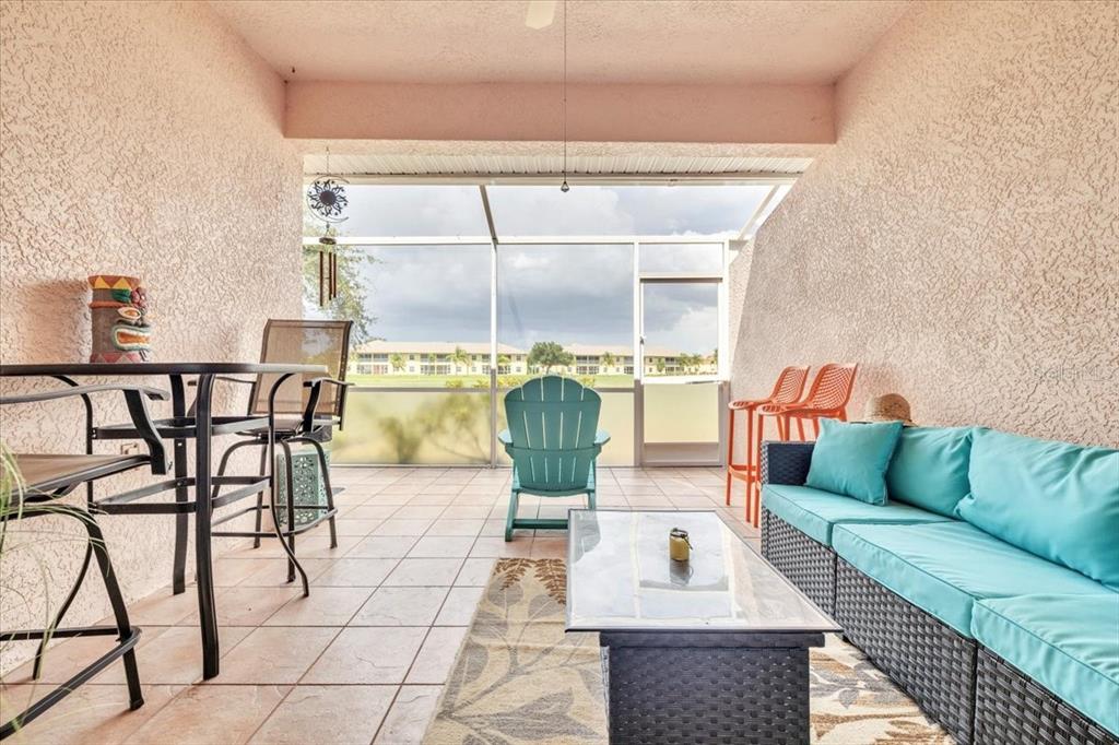 1260 Rio De Janeiro Avenue, Unit 102 Punta Gorda, FL 33983 - Photo 32 of 46 a living room with a couch and a table