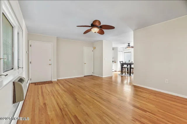 a view of empty room with wooden floor