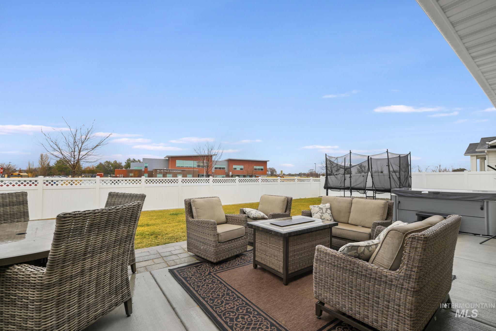3103 Moonrise Road Twin Falls, ID 83301 - Photo 31 of 40 Fenced backyard with a trampoline, a patio area, a hot tub, and outdoor lounge area