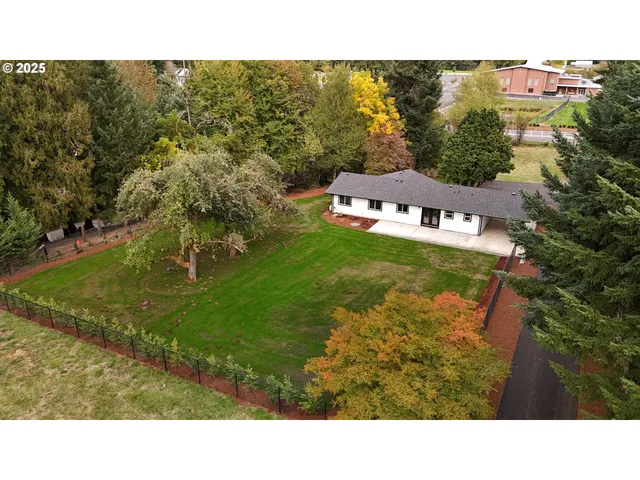 a view of a house with a yard and garage