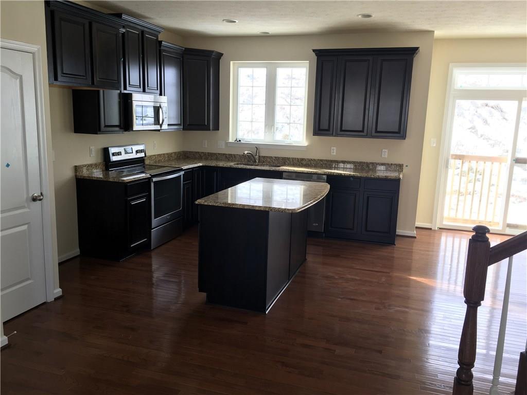 20 Truman Circle McKees Rocks, PA 15136 - Photo 2 of 5 Large kitchen island, stainless appliances and gleaming hardwood floors