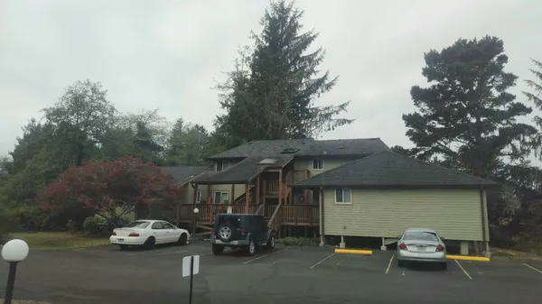 a street sign that is in front of flowers