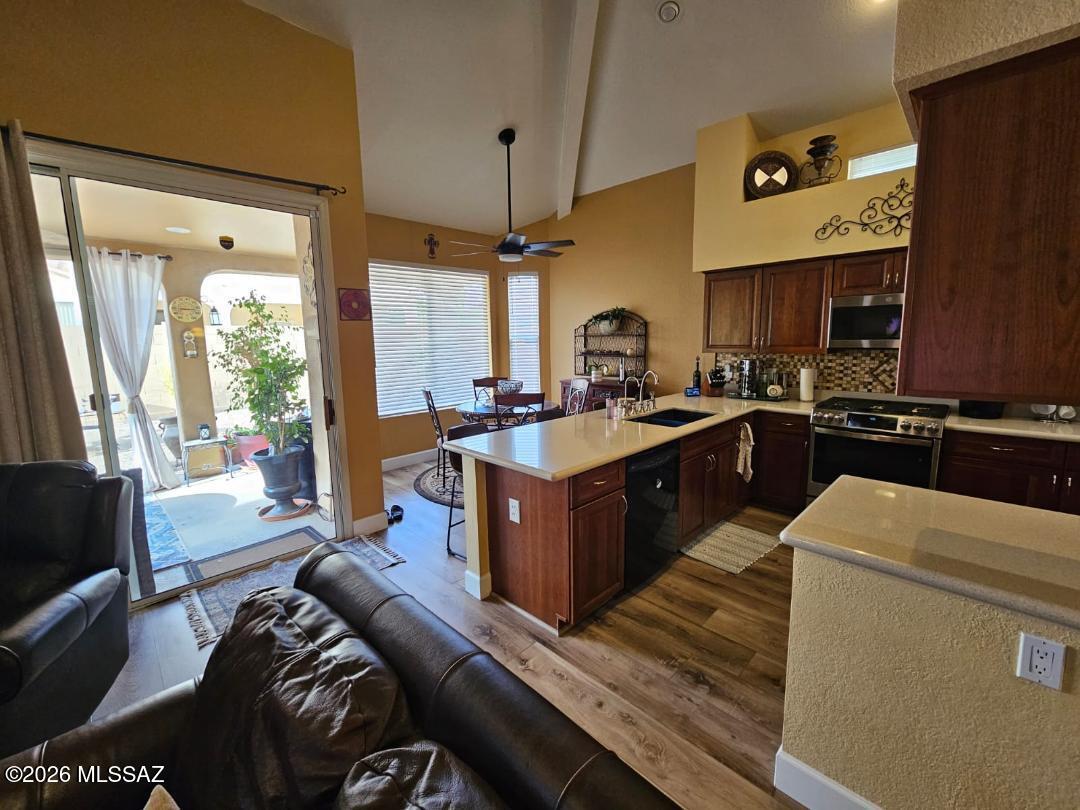 3130 West Star Ranch Trail Tucson, AZ 85742 - Photo 18 of 44 a living room with stainless steel appliances kitchen island granite countertop furniture a large window and a sink