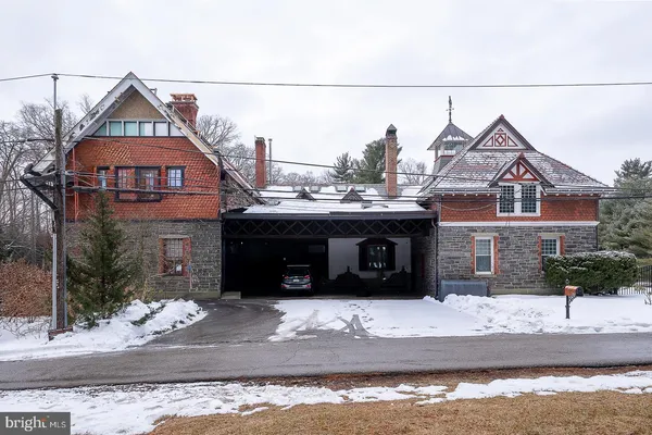 a view of a house with a balcony and yard