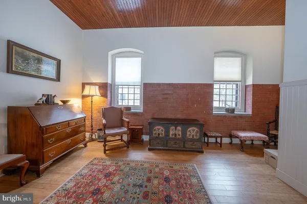 a view of a a dining room with furniture window and wooden floor