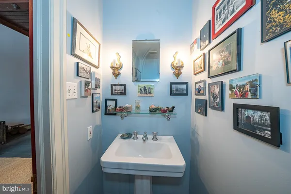 a kitchen with stainless steel appliances granite countertop a stove top oven a sink dishwasher a dining table and chairs with wooden floor