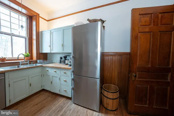 a bathroom with a sink a toilet and a large mirror
