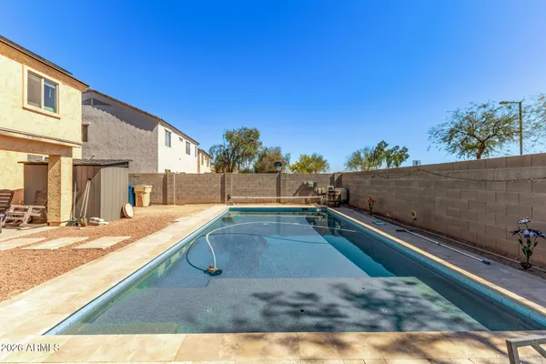 a view of a swimming pool with two chairs