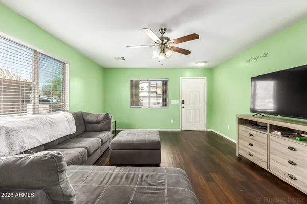 a living room with furniture and a flat screen tv
