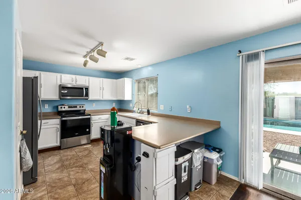 a kitchen with a stove a refrigerator and a stove top oven