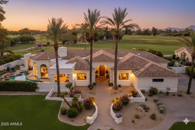 an aerial view of a house with garden space and ocean view