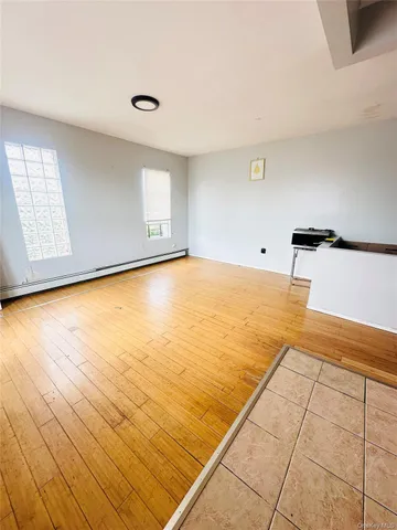 a view of a kitchen with kitchen island white cabinets and black appliances