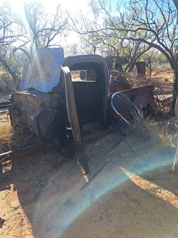 a view of a yard with wooden fence
