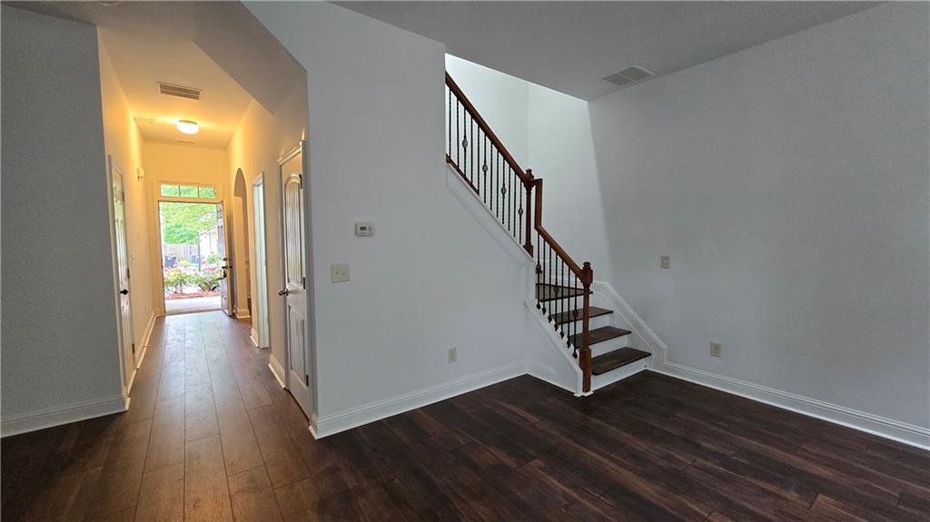 2275 Copper Trail Lane Northeast Buford, GA 30519 - Photo 11 of 39 a view of a hallway with wooden floor and stairs